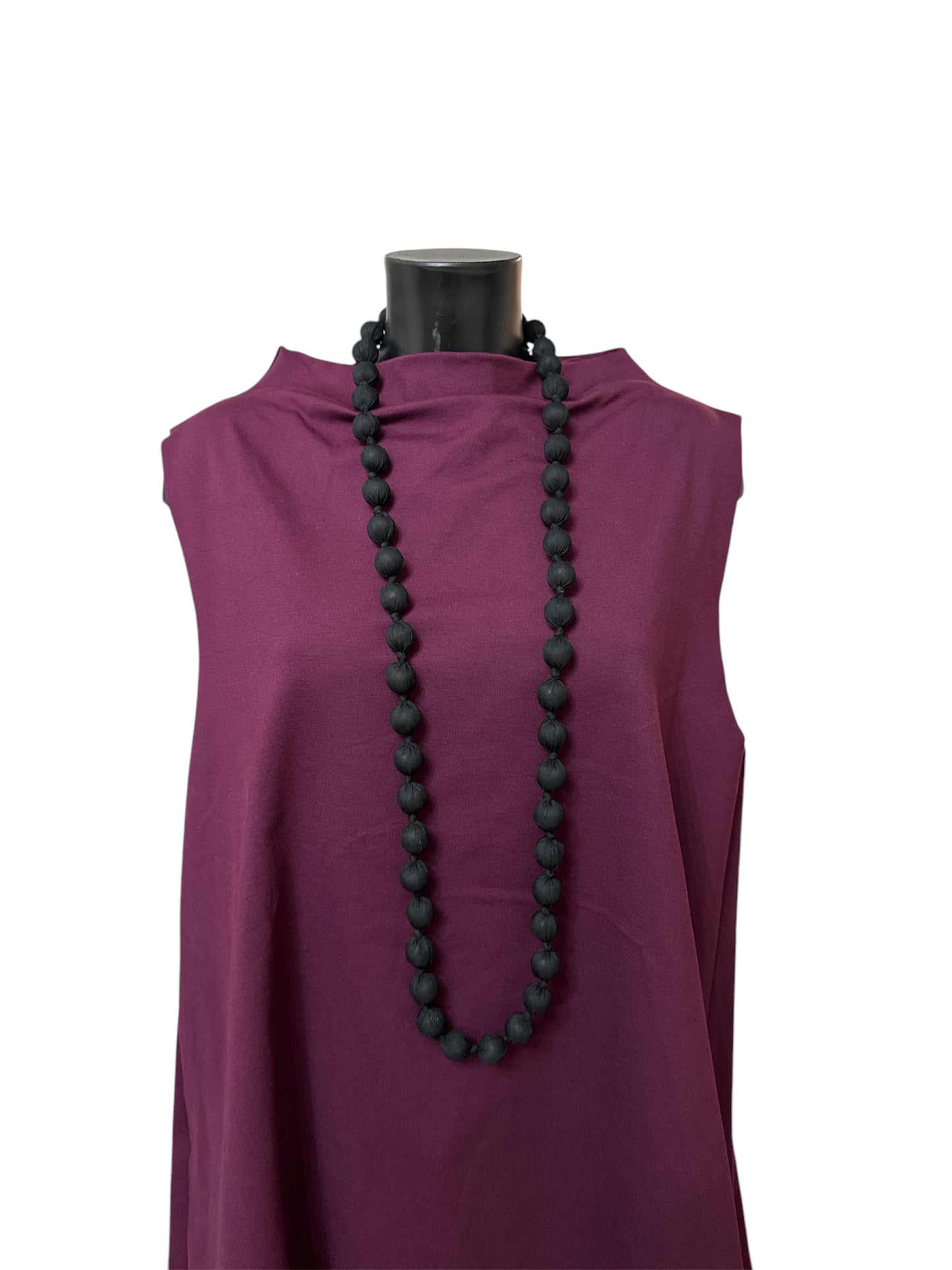 Long necklace with fabric-covered spheres